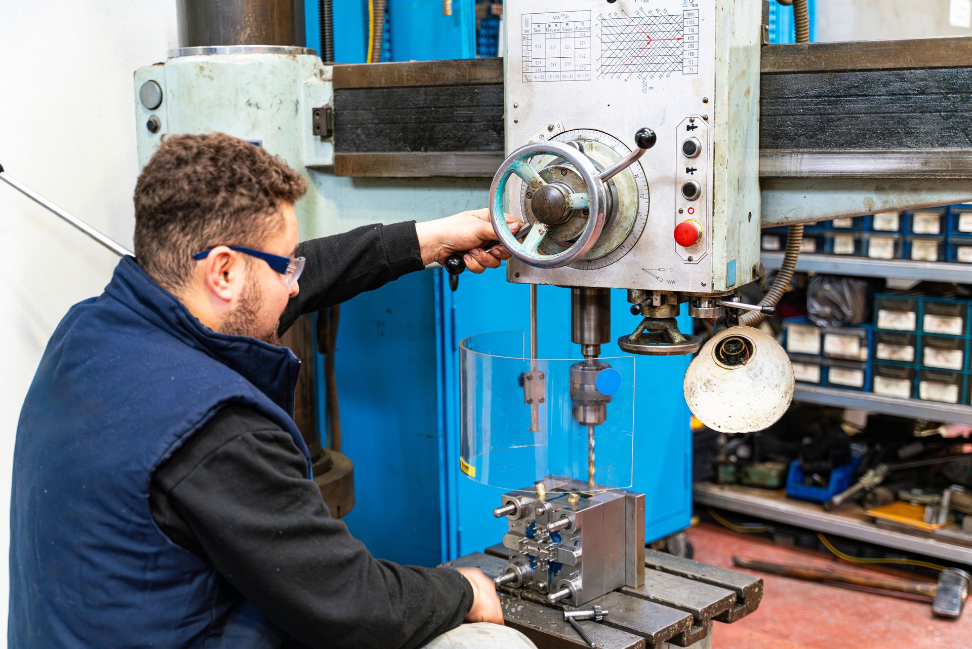 Lathe worker man working with a vernier and milling machine in a factory, using a caliper to check measurement.